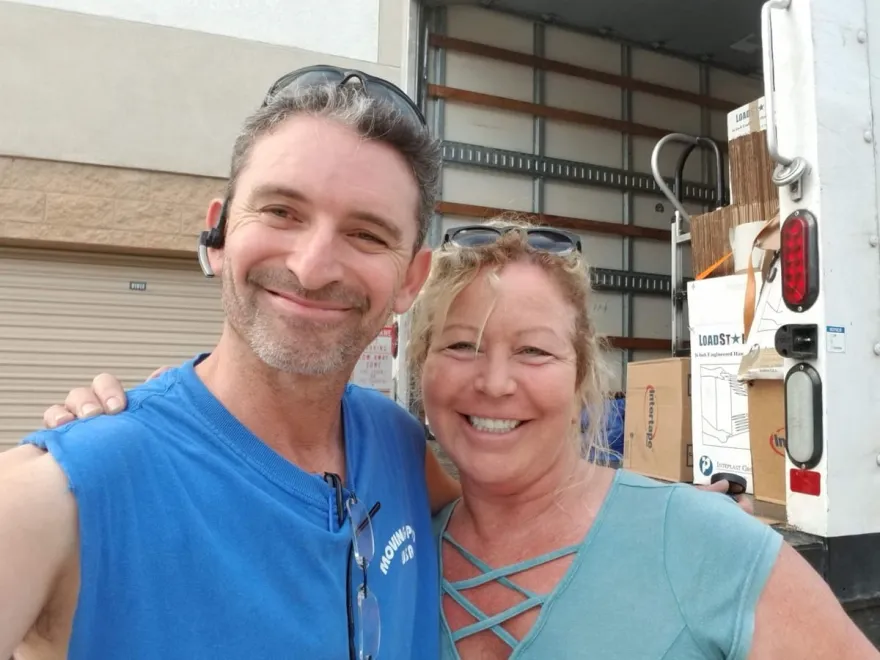 Moving Pro Inc movers with a smiling client