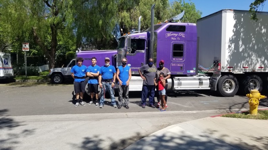 Moving Pro Inc team in front of their truck
